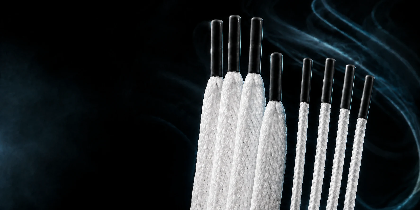 White lacrosse stringing kit with eight black-tipped strings, lit by soft cyan light against a dark studio background